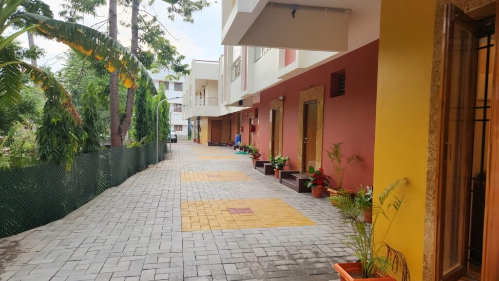 Landscaped internal walkway leading to the rooms at Vishaka INN