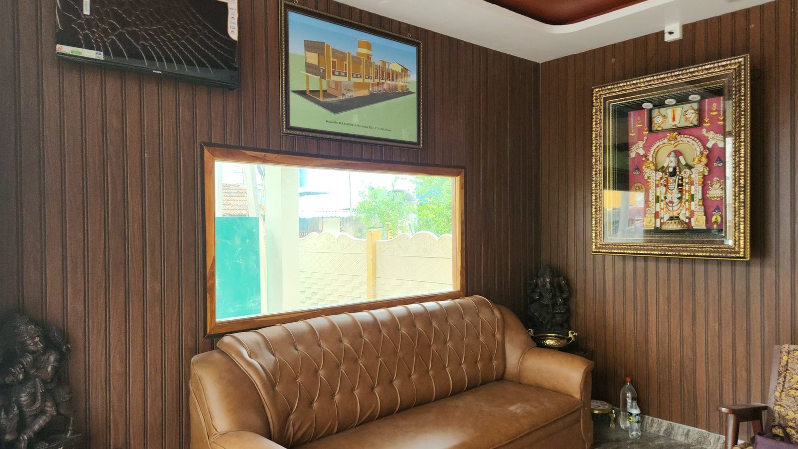 Lobby lounge with traditional Thanjavur artwork at Vishaka INN