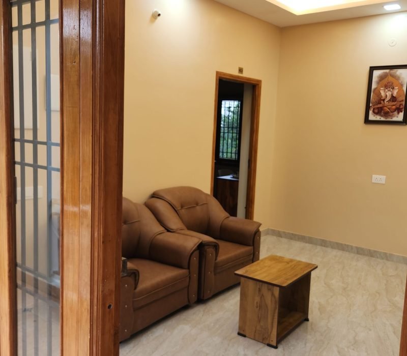 Separate living room with sofa seating in a Vishaka INN suite